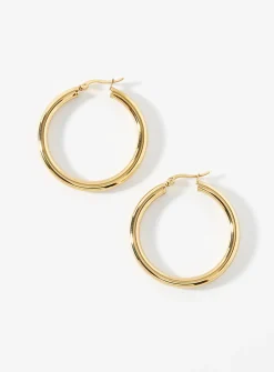 Large golden tubular hoops
